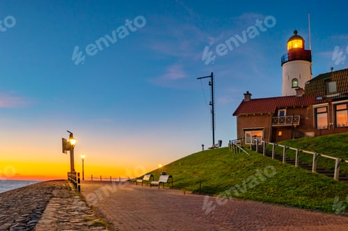 Preview: Urk Flevoland Netherlands sunset at the lighthouse and harbor of Urk Holland. Fishing village Urk