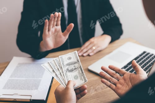 Preview: Businessperson refusing bribe given money by partner with anti bribery corruption concept.