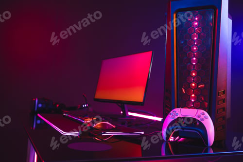 Preview: Composite of computer with video game accessories with copy space on neon background