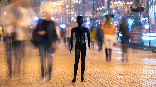 Preview: The mannequin standing on the crowd street. evening time