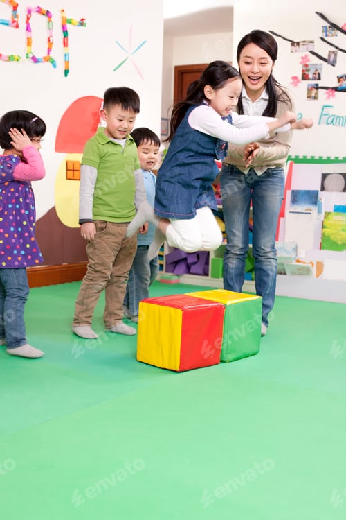 Preview: Cheerful kindergarten children playing games with teacher