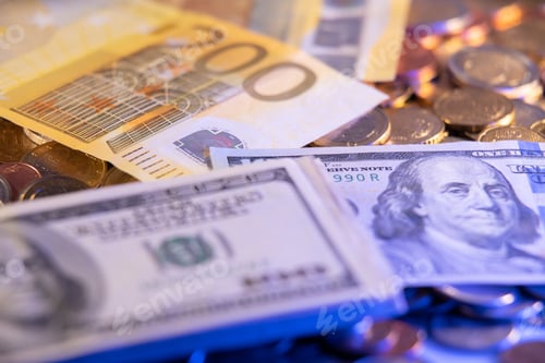 Preview: Closeup of Euro coins and euro and dollar banknotes on a stack