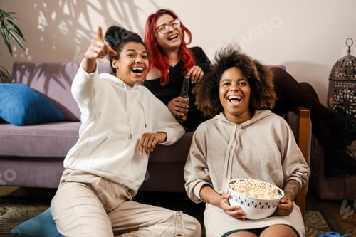 Three happy multiethnic women friends