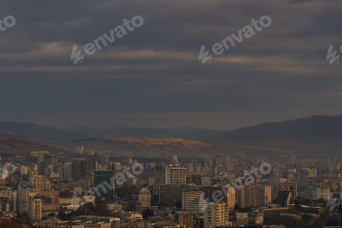 Preview: Scenic view of Tbilisi surrounded by majestic mountains in the distance at sunrise in Georgia
