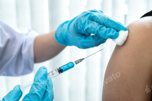 Preview: Doctor holding syringe and using cotton before injection coronavirus vaccine in shoulder of patient