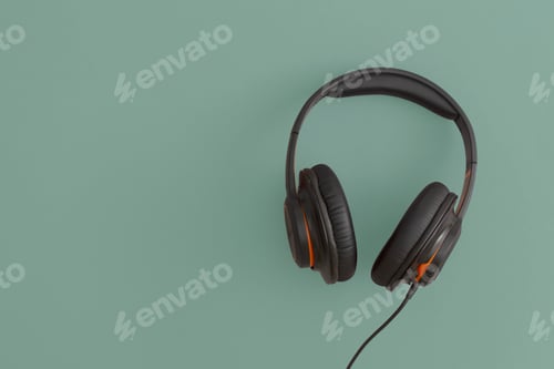 Preview: Headphones on green background. Music concept. Flat lay composition.