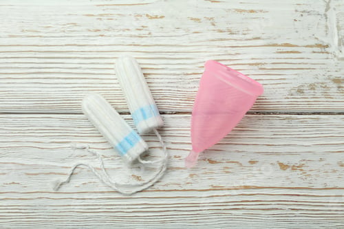 Preview: Concept of menstruation on wooden background, top view