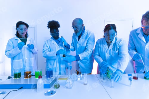 Preview: Scientists working with colorful liquids in laboratory research experiment