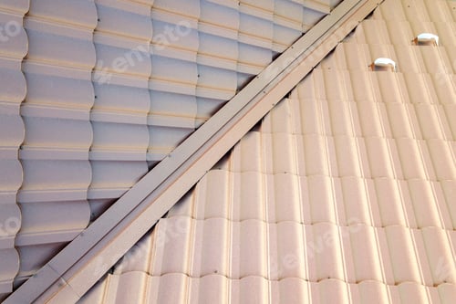 Preview: Detail view of house rooftop covered with brown metal tile sheets.