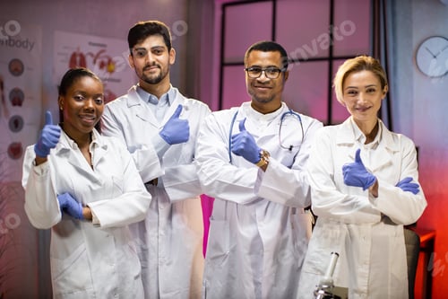 Preview: Smiling group of scientists in modern laboratory with male african american leader, mix race