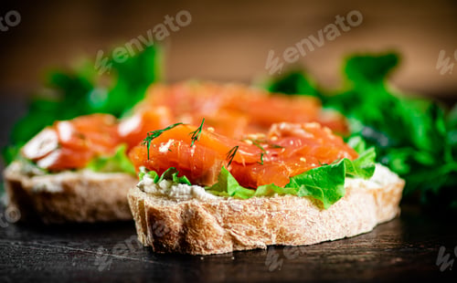 Preview: Sandwich with pieces of salmon and greens.
