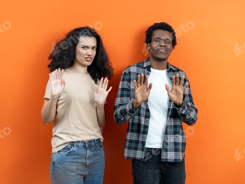 Preview: Reluctant Young Couple Refusing Offer With Hands Up