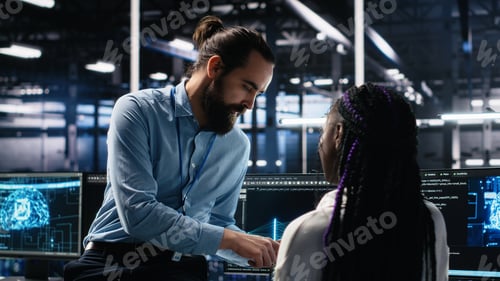 Preview: System administrator and employee in data center coding with generative AI