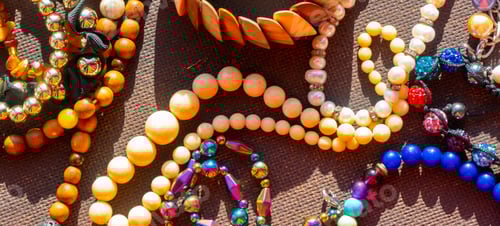 Preview: a lot of costume jewelry with different materials on a black background