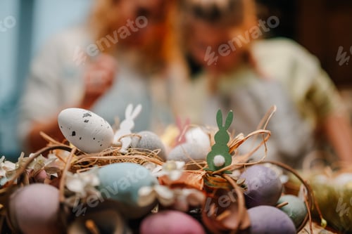 Preview: Easter eggs nest with bunnies celebrating spring holidays
