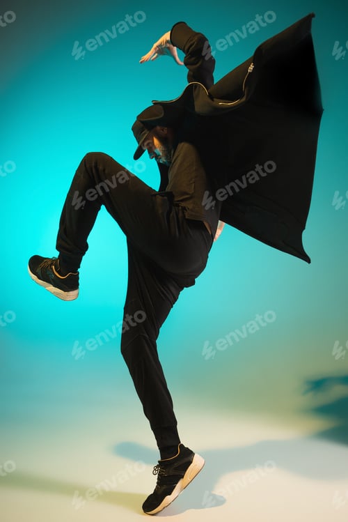 Preview: The silhouette of one hip hop male break dancer dancing on colorful background
