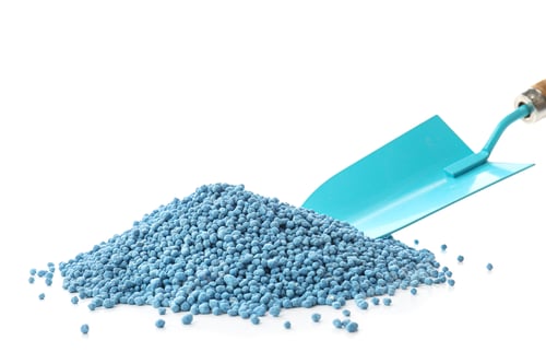 Preview: Pile of granular mineral fertilizer with shovel on white background
