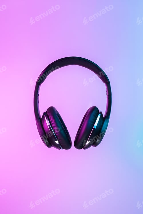 Preview: Retro 90s style photo of black stylish wireless headphone in neon lights.