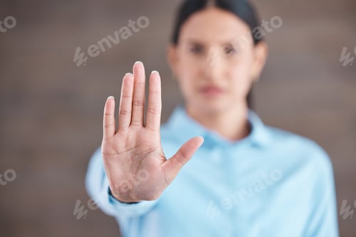 Preview: Closeup hand of a mixed race business woman gesturing stop while standing in her office. Stop sexis