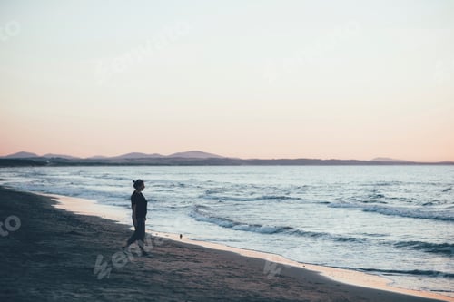 Preview: A solitary stroll by the sea at dusk.
