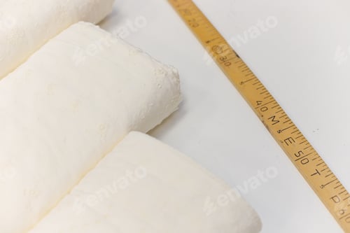 Preview: Tailor wooden meter with fabric rolls on white background