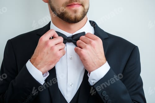 Preview: Well Dressed Man Adjusting His Bow Tie
