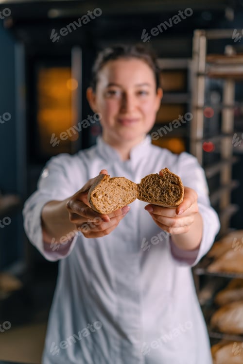 Preview: baker showing hot cut freshly baked crispy and puffy bread bun bakery