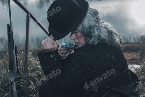 Preview: dark evil character holding euro cash outdoors a cloudy dark day - evil war grief concept