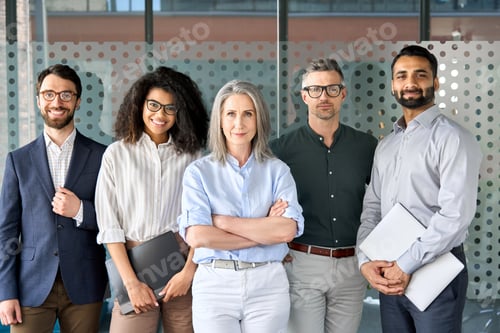 Preview: Happy diverse business people team standing in office, group portrait.