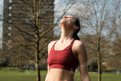 Preview: Relaxed image of fitness model meditating with eyes closed.