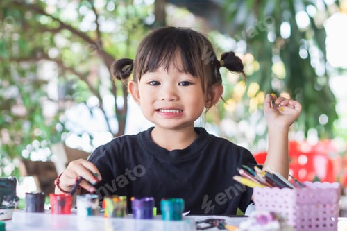 Preview: Smiling Girl Painting with Colorful Paints Indoors
