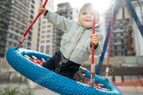 Preview: A kid walks on a children's playground in the courtyard of an apartment building
