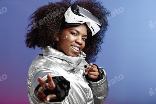 Preview: Modern curly brown-haired girl dressed in a silver-colored jacket wearing on her head the virtual