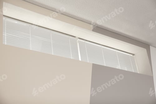 Preview: Modern window with closed white blinds indoors