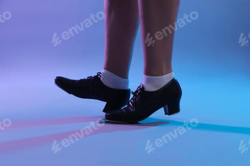 Preview: Teenage girl in tap shoes dancing on color background, closeup