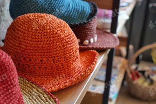 Preview: Colorful handmade hats displayed in a craft shop