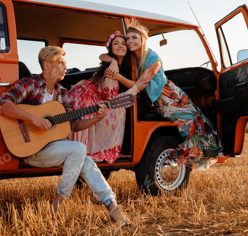 Preview: Hippie friends with guitar on a road trip
