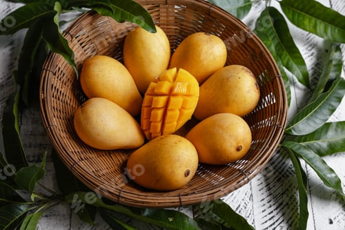 Preview: yellow ripe mangoes in basket