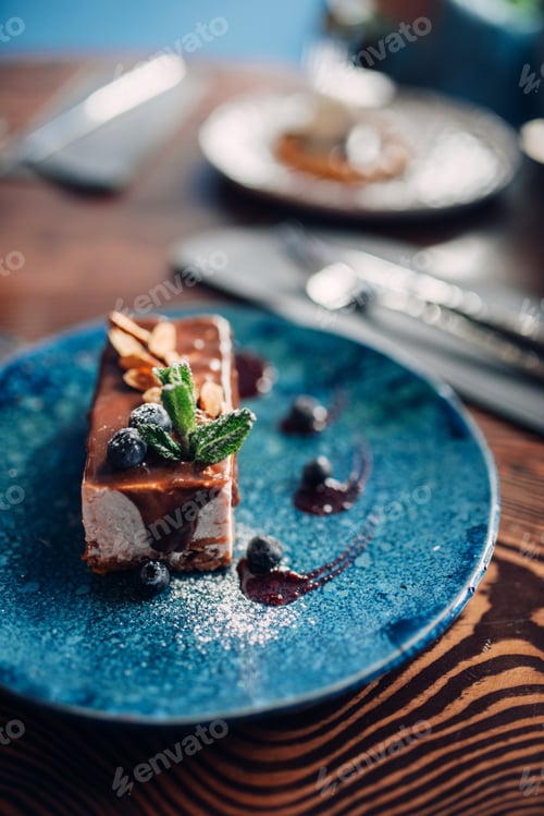 Preview: Sweet dessert on a plate on wooden table, nobody