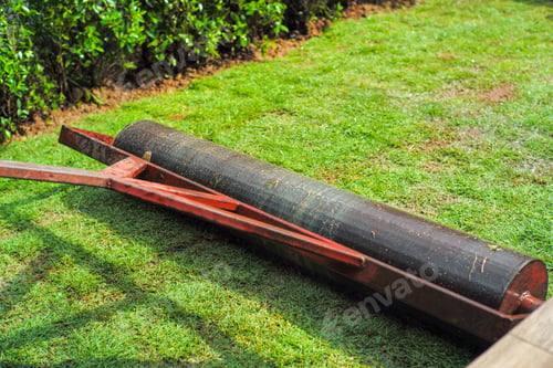 Preview: Closeup heavy steel drum for pressing the lawn field during growing the grass