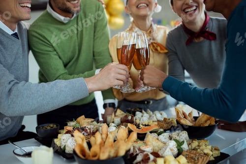 Preview: Close-up of business colleagues toasting with Champagne on a party in the office.