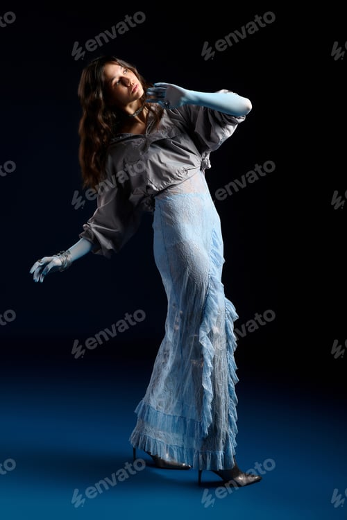Preview: Stylish young woman showcasing modern fashion in dramatic studio lighting