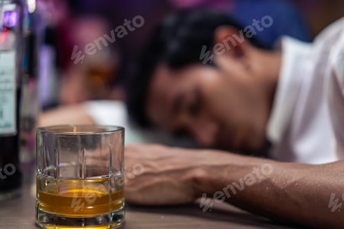 Preview: Asian depression man feeling heart broken and drinking beer in a bar.
