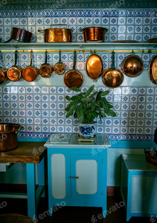Preview: an old vintage kitchen with copper pots and pans with a blue tiled wall
