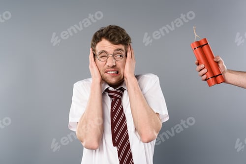 Preview: frightened man holding hands on ears while another holding dynamite