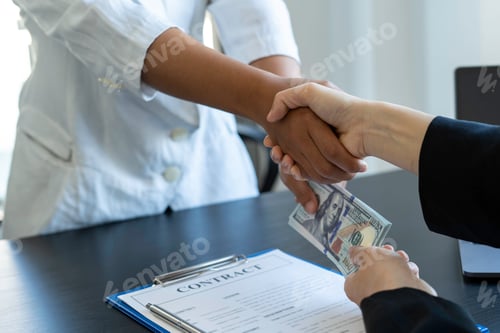 Preview: Asian businesswomen give dollars to sign home and real estate contracts and congratulate them for wo
