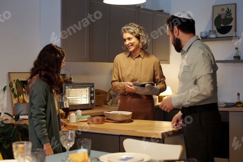 Preview: Happy mature Jewish woman looking at her daughter in the kitchen