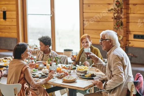 Preview: Happy young woman and mature man with drinks interacting by festive table