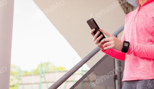 Preview: Woman using mobile phone in staircase