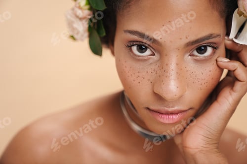 Preview: Portrait of half-naked african american woman with flowers in her hair